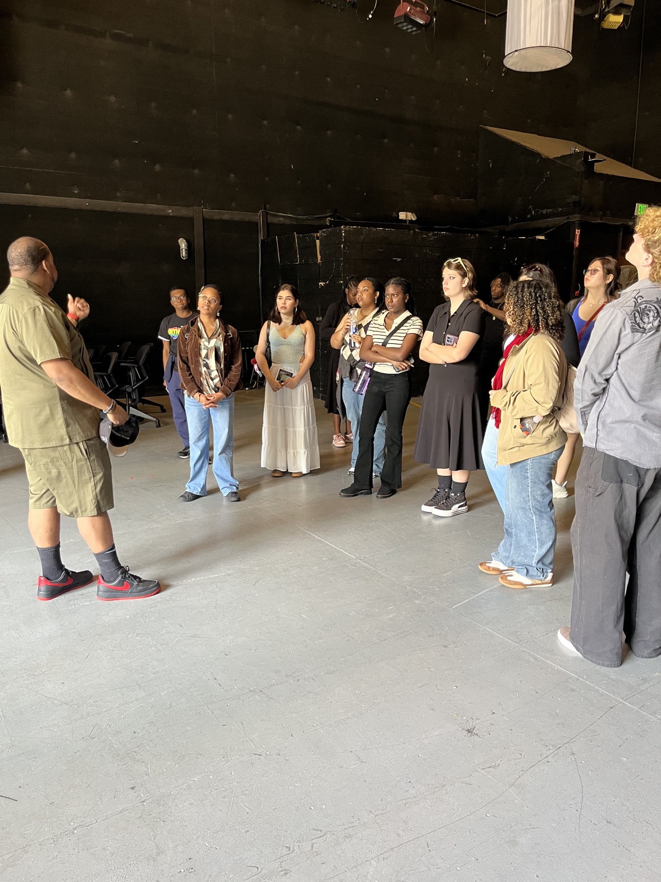 Rebuilt Village students learning in a film studio beneath overhead production lights